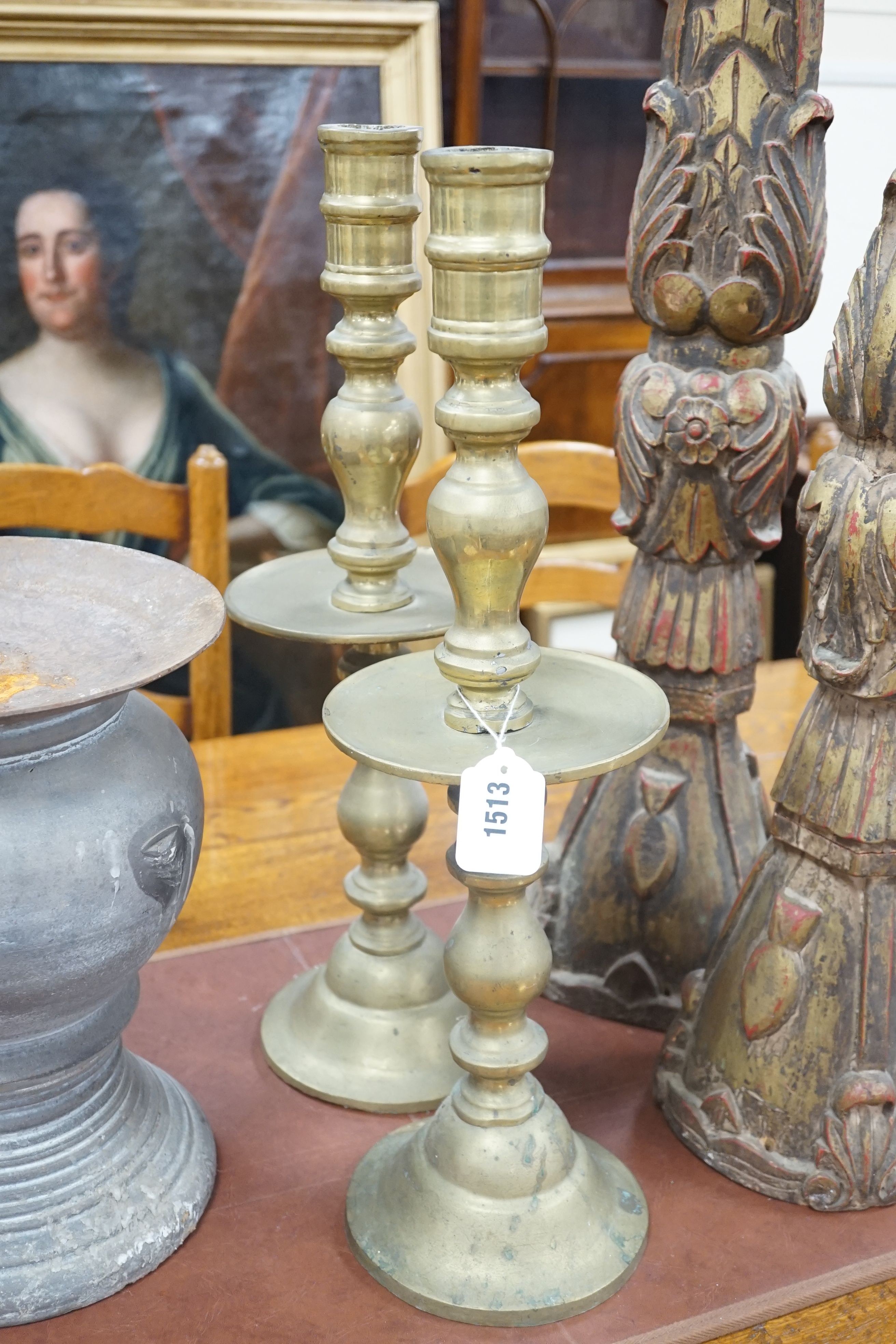 A pair of gilt carved candlesticks, a large turned candlestick, a pair of brass candlesticks and a squat metal candle stick (6), tallest 140cms.